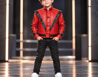 May include: A red leather jacket with black V-shaped panels, a high collar, and button closures, paired with black slim-fit trousers and white high-top trainers. The jacket features quilted shoulder detailing and adjustable buckle straps at the cuffs.