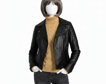 May include: A black leather jacket with a classic biker style, featuring a notched collar, asymmetrical zip, and quilted shoulder detailing. The jacket is displayed on a mannequin wearing a tan turtleneck sweater and dark grey jeans.