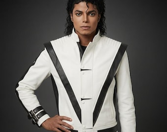 May include: A white leather jacket with black detailing, including a high collar, shoulder pads, and a V-shaped design. The jacket has a buckled belt at the waist and cuffs. A classic style jacket.