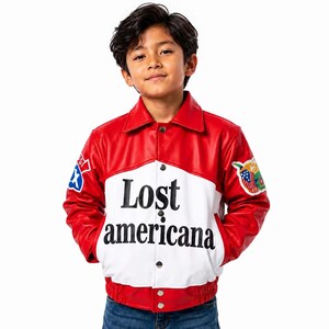 May include: A red and white jacket with a collar and snap buttons. The front features the black text 'Lost americana'. The sleeves have colorful patches, including a blue and white star emblem on the right and a flag-themed patch on the left.