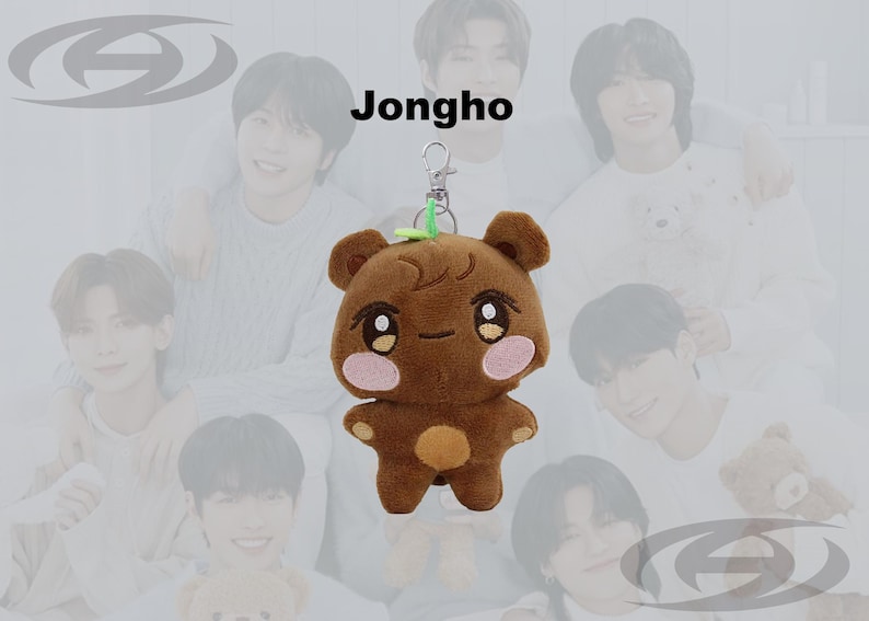May include: Brown plush bear keychain with a green leaf accent. The bear has a cute face with pink cheeks and a small orange belly. The word "Jongho" is written above the bear.