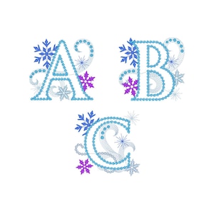 May include: Three embroidered letters, A, B, and C, in a light blue color, each adorned with snowflakes and starbursts. The letters have a decorative, ornate design, with purple and silver accents, perfect for winter-themed crafts.