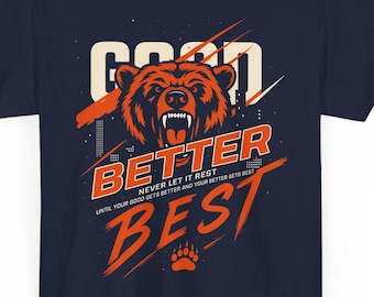 May include: Navy blue t-shirt with a graphic design featuring a bear's head in orange and white, and the words "GOOD, BETTER, BEST" in a stylized font. The shirt also includes the text "NEVER LET IT REST".