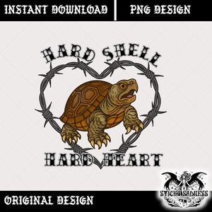 May include: A digital design featuring a brown turtle inside a heart-shaped barbed wire frame. The words "HARD SHELL" and "HARD HEART" are above and below the turtle. The design is labeled "ORIGINAL DESIGN" and "PNG DESIGN".
