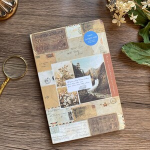 May include: A vintage-style journal with a collage of old stamps, postcards, and handwritten letters. The cover features a scenic waterfall image and the text "If you shed tears when you miss the sun, you also miss the stars."