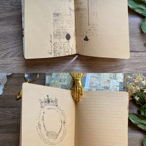 May include: Open journal with tan pages featuring vintage-style illustrations and handwritten text. A gold-colored hand-shaped bookmark holds the pages open. The journal has a pink ribbon bookmark and is part of a stationery collection.