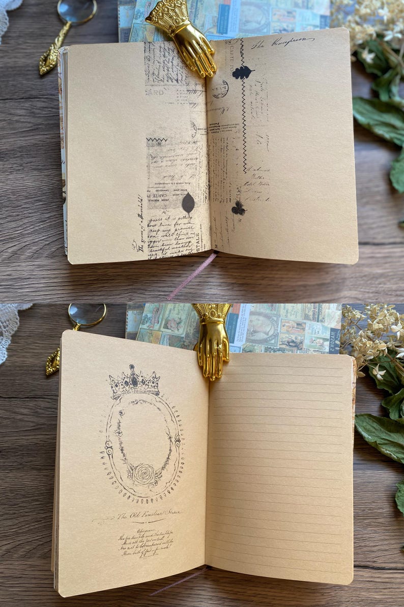 May include: Open journal with tan pages featuring vintage-style illustrations and handwritten text. A gold-colored hand-shaped bookmark holds the pages open. The journal has a pink ribbon bookmark and is part of a stationery collection.