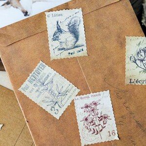 May include: A collection of vintage-style postage stamps with botanical and animal illustrations, including a squirrel and floral designs. The stamps are affixed to a brown paper envelope, evoking a sense of nostalgia and artistic flair.