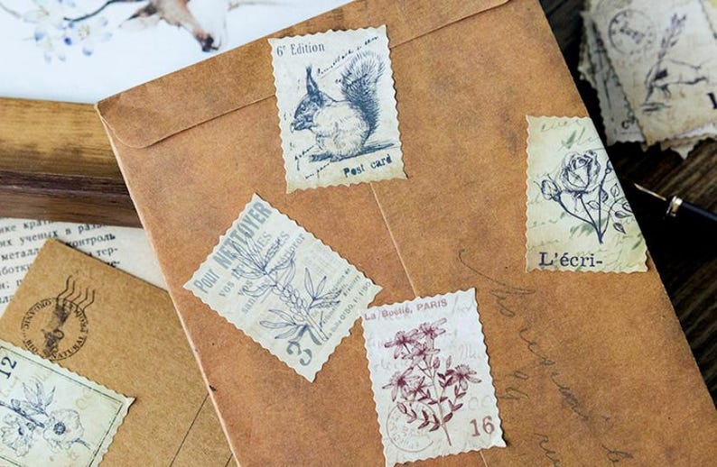 May include: A collection of vintage-style postage stamps with botanical and animal illustrations, including a squirrel and floral designs. The stamps are affixed to a brown paper envelope, evoking a sense of nostalgia and artistic flair.