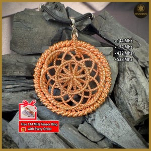 May include: A copper-colored pendant necklace with a circular, woven design. The pendant hangs from a black cord. Text on the image includes "144 Mhz", "177 Mhz", "432 Mhz", and "528 Mhz". The image also includes the text "Free 144 MHz Tensor Ring with Every Order".