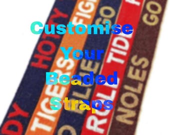 May include: Customizable beaded straps in various colors, including orange, navy, red, and brown. Text includes "HOY TODDY", "FIGHT TIGERS", "GO BLUE", "ROLL TIDE", and "GO NOLES".