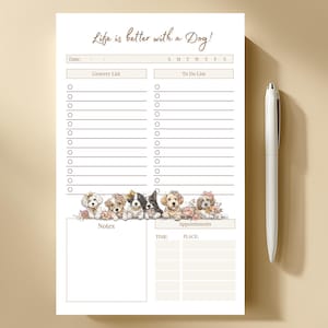 Pode incluir: Um bloco de notas branco com o texto "Life is better with a Dog!" e uma ilustração de cachorros. O bloco de notas inclui secções para uma lista de compras, uma lista de tarefas, notas e compromissos. Uma caneta branca está à direita.