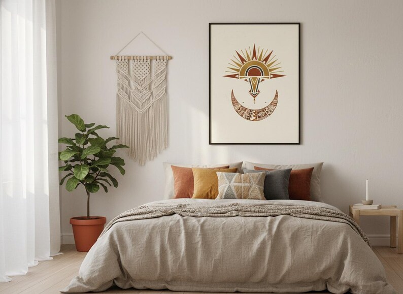 African tribal sun mask art print in black frame displayed above a boho bedroom bed with macrame wall hanging, earthy terracotta and cream tones, digital download wall decor