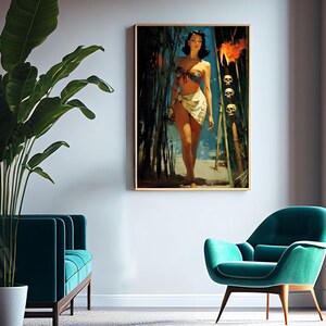 May include: A framed print of a vintage-style illustration of a woman in a bikini walking on a beach. The artwork has a gold frame and is displayed on a white wall. The room also features a teal sofa, chair, and a large potted plant.