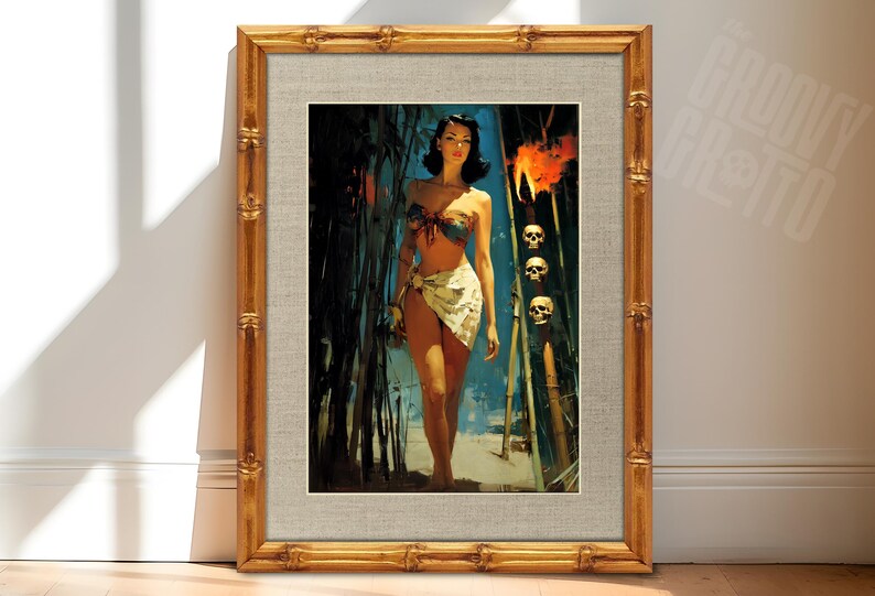 May include: Framed vintage-style print featuring a woman in a bikini and sarong, walking through bamboo. The artwork has a retro aesthetic with a gold bamboo-style frame. Skulls are visible in the background, adding a touch of intrigue.