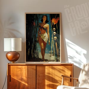 May include: A framed vintage-style print featuring a woman in a tropical setting. The artwork has a retro aesthetic with a color palette of blues, greens, and flesh tones. The print is displayed on a wooden cabinet with a lamp.