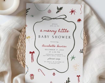 May include: A baby shower invitation with a festive design. The invitation features the text "a merry little BABY SHOWER" in red and black, with decorative elements like stars, bows, and ornaments. The invitation is on a white background.
