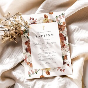 Peut inclure: Invitation de baptême avec un motif floral dans les tons de blanc, orange et marron. L'invitation comprend le mot "BAPTISM" et les détails de l'événement, dont le nom "Amanda Jackson" et la date du 30 juin 2026.
