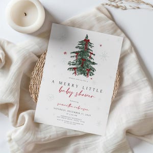 May include: A baby shower invitation with a Christmas theme. The invitation features a watercolor illustration of a Christmas tree adorned with red bows and snowflakes. The text reads "A Merry Little Baby Shower" in red script, with event details below.