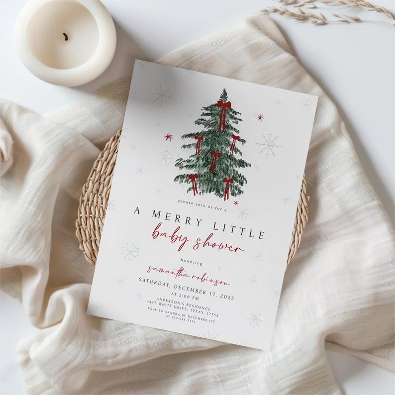 May include: A baby shower invitation with a Christmas theme. The invitation features a watercolor illustration of a Christmas tree adorned with red bows and snowflakes. The text reads "A Merry Little Baby Shower" in red script, with event details below.
