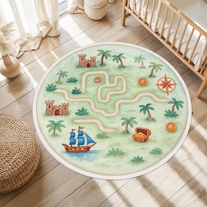 May include: A circular children's rug with a pirate map design. The rug features a light green background with a winding path, palm trees, castles, a treasure chest, a ship, and a compass rose. The rug has a cream-coloured border.