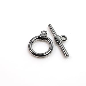 May include: Silver-toned metal toggle clasp with a round ring and a bar with a small loop. This clasp is used for necklaces, bracelets, or other jewelry.