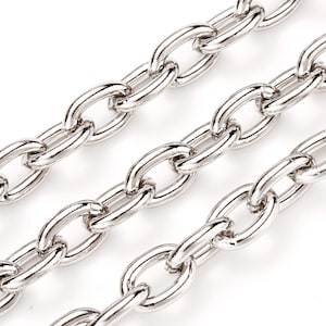 May include: Three strands of silver chain with oval links. The chain is smooth and shiny.