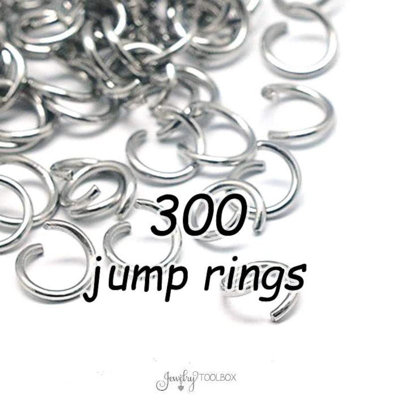May include: A close-up image of 300 silver jump rings. The jump rings are small and round, and they are perfect for making jewelry.