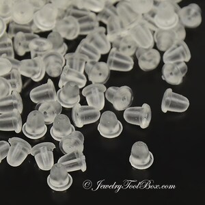 May include: A large quantity of clear plastic earring backs. The backs are small and round with a small hole in the center. They are designed to be used with post earrings.