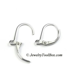 May include: Two silver earring hooks with a spring clasp closure. The hooks are made of metal and are designed to be used with earrings.