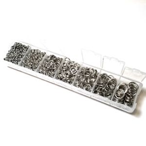 May include: A clear plastic container with six compartments filled with silver jump rings of various sizes.