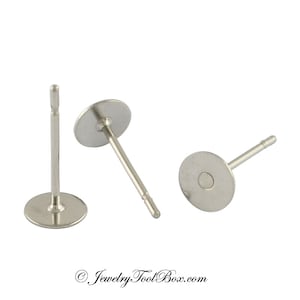May include: Three silver earring posts with flat round backs. The posts are about 1 inch long.