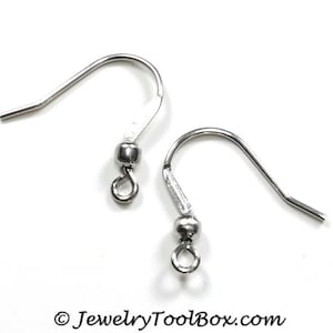 May include: Two silver earring hooks with a small ball at the top of each hook.