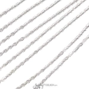 May include: Multiple strands of silver chain, a popular material for jewelry making.