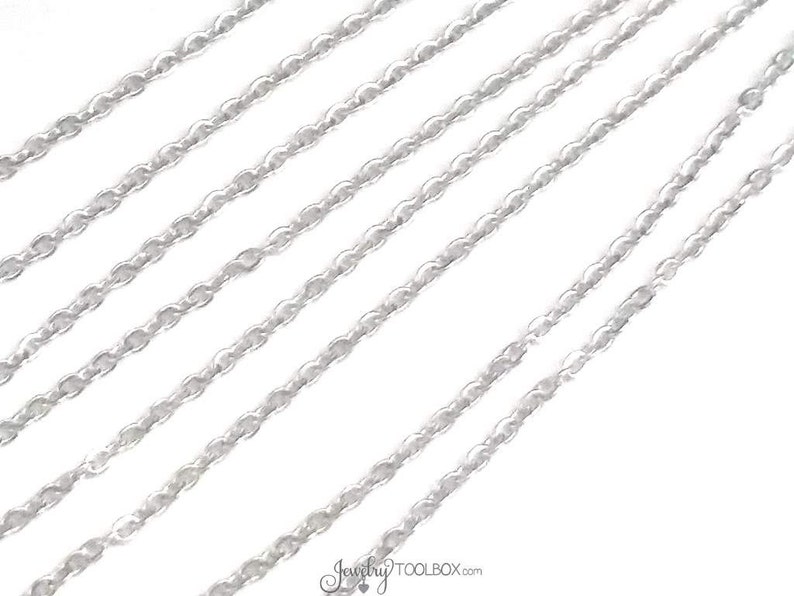 May include: Multiple strands of silver chain, a popular material for jewelry making.