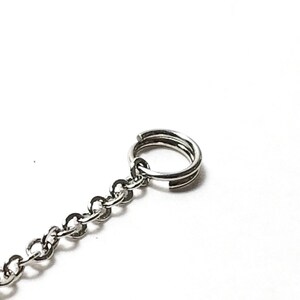 May include: A silver chain with a silver jump ring at the end.