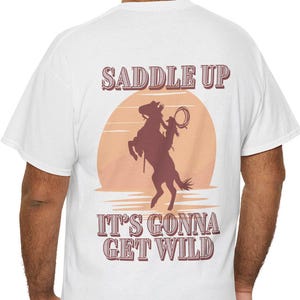 Saddle Up Unisex Heavy Cotton Tee - Wild West Graphic Tee, Cowboy T-Shirt, Rodeo Apparel, Adventure Shirt, Fun Outdoor Wear