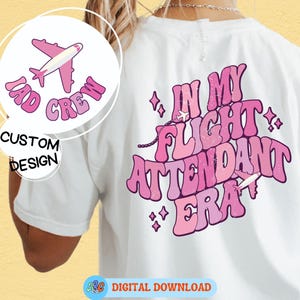 May include: White t-shirt with a pink and white graphic design. The front features a pink airplane and the words "TAD CREW" in a bubble font. The back says "IN MY FLIGHT ATTENDANT ERA" in pink.