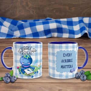May include: White ceramic mug with a blue interior and handle. The mug features a blue and white gingham pattern and the text "SCRIBBLE. SIP. REPEAT" and "EVERY SCRIBBLE MATTERS". A blueberry character is also featured on the mug.