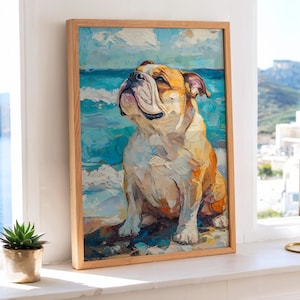 May include: A framed art print of a bulldog sitting on a beach, with a blue ocean and sky background. The artwork features a light brown wooden frame and a colorful, textured painting style. The dog is depicted with a light brown and white coat.