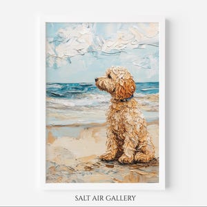 May include: Oil painting of a golden doodle dog on a sandy beach, looking out to sea. The artwork shows a blue sky with textured white clouds and blue waves. The dog wears a blue collar. The words "SALT AIR GALLERY" are at the bottom.
