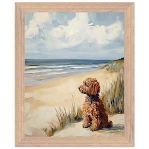 May include: Framed art print of a dog sitting on a sandy beach, gazing at the ocean. The artwork features a brown dog with a blue collar, set against a backdrop of a blue sky, white clouds, and ocean waves. The frame is light brown.
