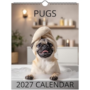 May include: A 2027 wall calendar titled PUGS featuring a fawn-colored pug with a black muzzle wearing a beige towel wrapped around its head, sitting in a white bathtub filled with soap bubbles and foam.