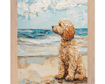 May include: Framed art print of a golden doodle dog sitting on a sandy beach, gazing at the ocean. The painting features textured brushstrokes in shades of tan, blue, and white, with a light wood frame.
