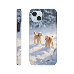 May include: A phone case depicting a winter scene with two golden dogs in a snowy landscape. The dogs are in the snow, with a forest in the background. The case is designed to fit a smartphone.