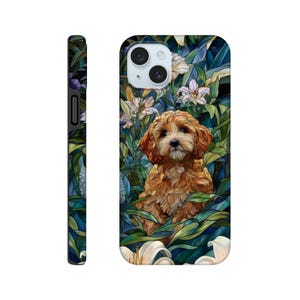 May include: A phone case featuring a golden-brown puppy sitting amidst white lilies and lush green foliage. The case has a glossy finish and a black border. The design is a digital illustration with a stained-glass effect.