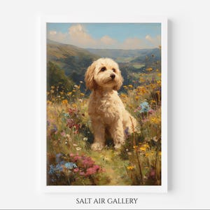 May include: A framed art print depicting a golden dog in a field of wildflowers. The dog is the central figure, set against a backdrop of rolling hills and a blue sky. The artwork has a painterly style, with visible brushstrokes and a soft, warm colour palette.