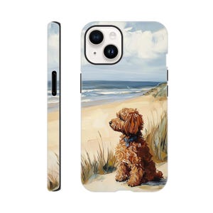 May include: A phone case with a painting of a brown dog on a sandy beach, looking out to sea. The case has a white background with a side view. The artwork depicts blue skies, ocean waves, and coastal grasses.
