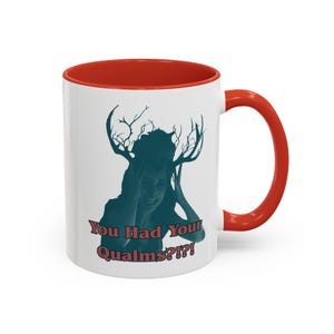 May include: A white ceramic mug with a bright red interior and handle. The front features a dark teal graphic of a person with large, branching antlers on their head, with the text "You Had Your Qualms?!?!" printed in red below the image.