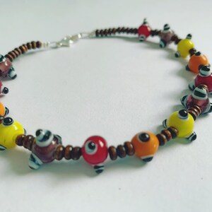 May include: A set of three ceramic mugs with a speckled, matte finish. The mugs are in shades of cream, light gray, and dark gray. Each mug has a simple, minimalist design and a rounded handle. The mugs are likely for coffee or tea.